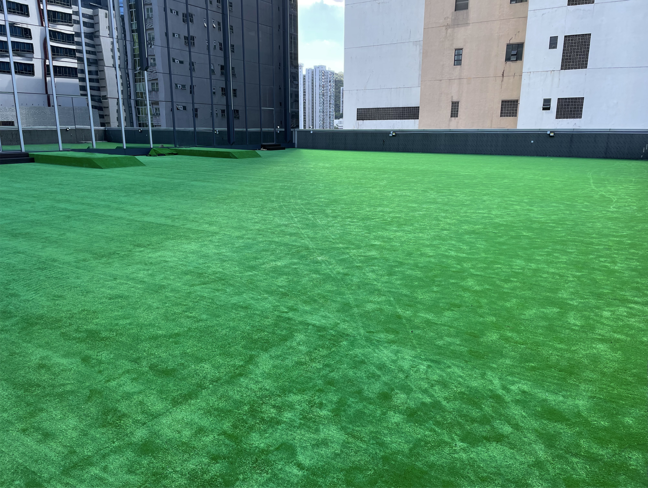 Artificial grass decoration on rooftop common area.